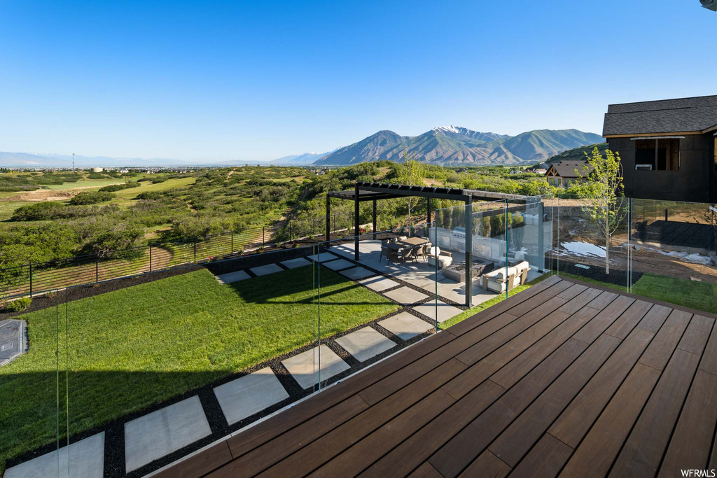 Wooden terrace with a lawn and a mountain view
