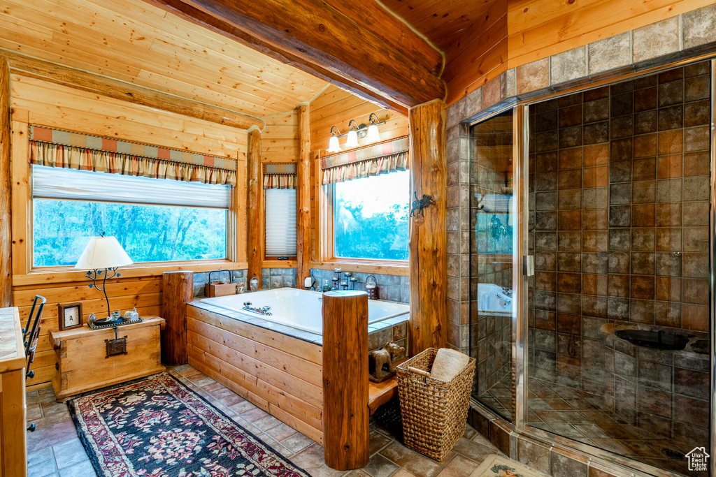 Bathroom with separate shower and tub, wooden walls, tile floors, wooden ceiling, and vanity
