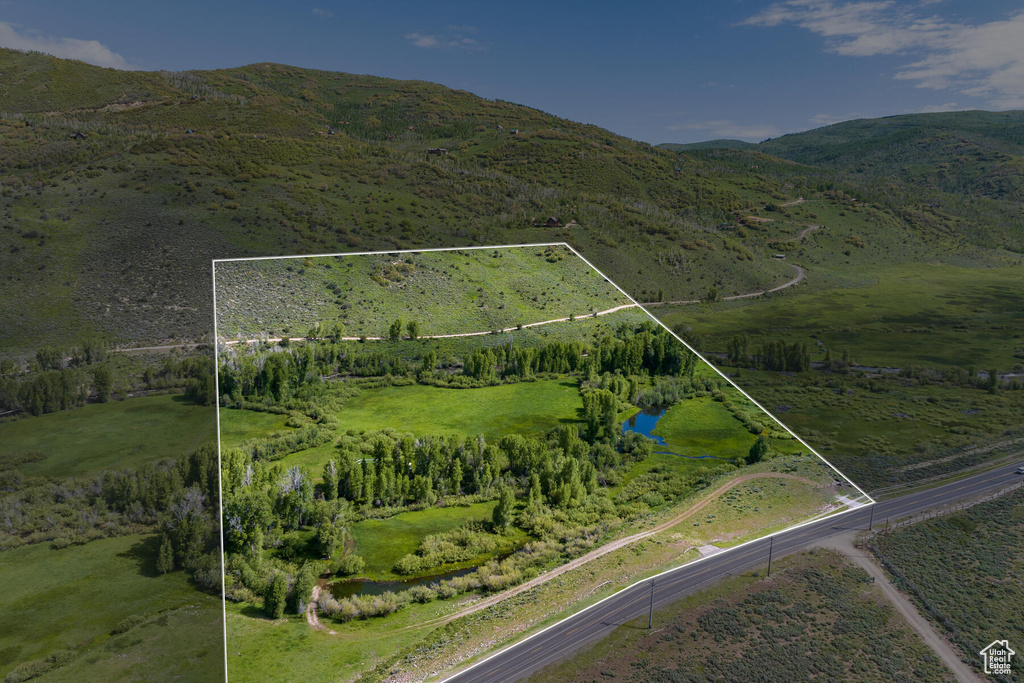 Birds eye view of property with a rural view and a mountain view