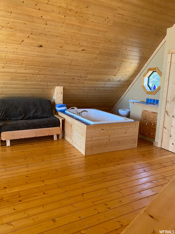 Unfurnished bedroom with light wood-type flooring, wooden ceiling, and vaulted ceiling