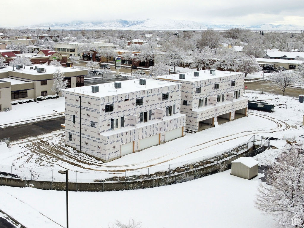 Snowy aerial view featuring a mountain view