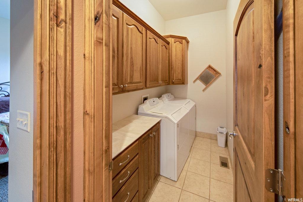 Laundry room with tile flooring and washer / dryer