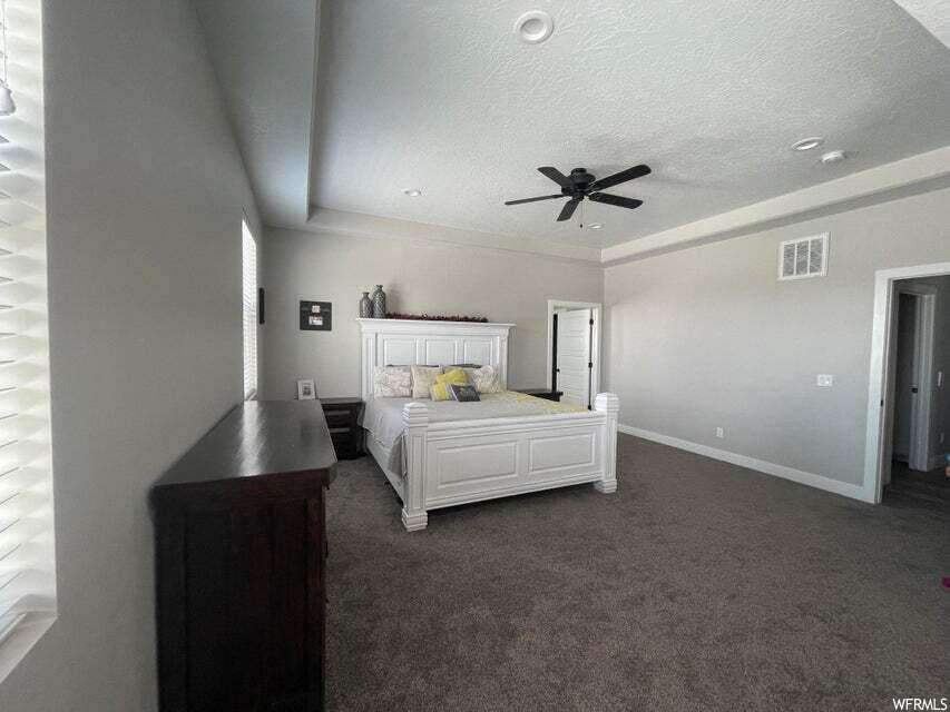 Bedroom with a ceiling fan and carpet
