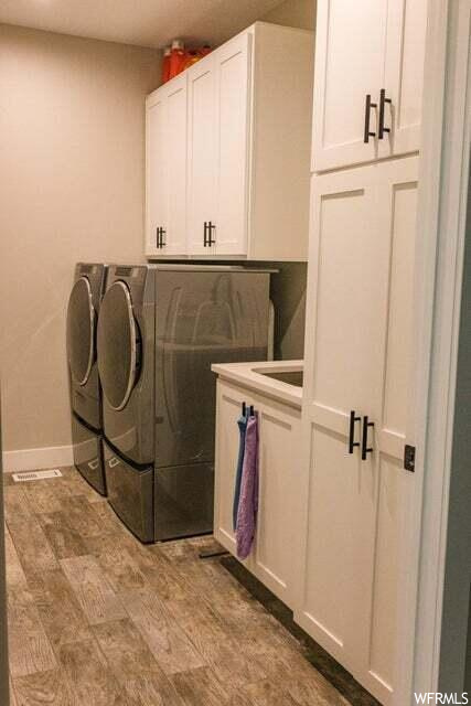Clothes washing area with tile flooring