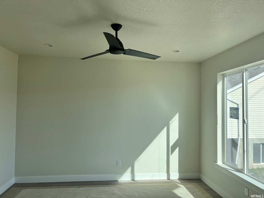 Spare room featuring a textured ceiling and ceiling fan