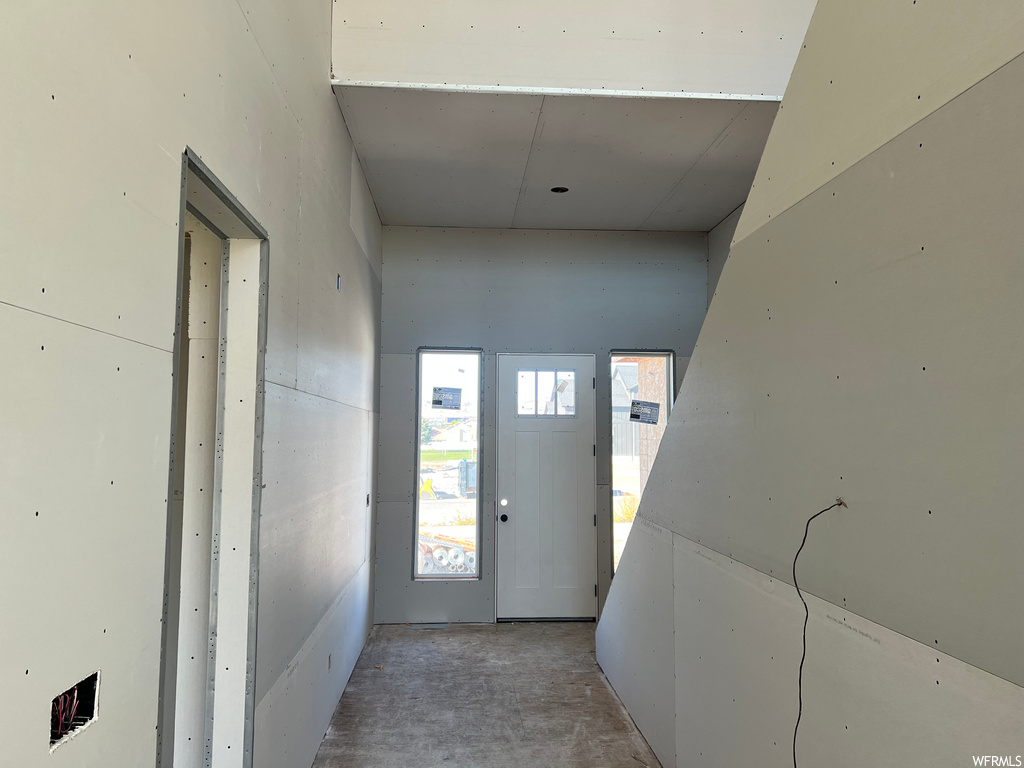 Doorway to outside featuring concrete flooring