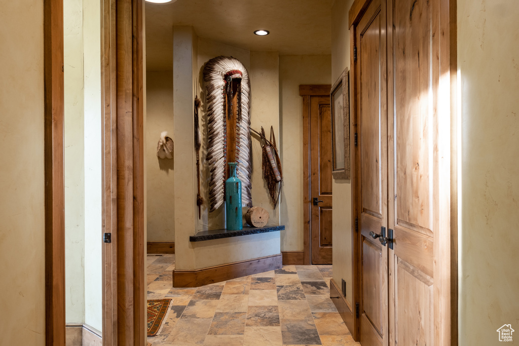 Hall with recessed lighting and stone finish flooring