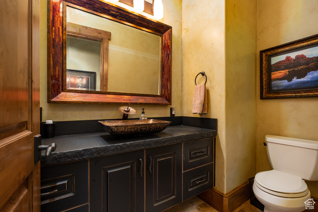 Half bath featuring vanity and toilet