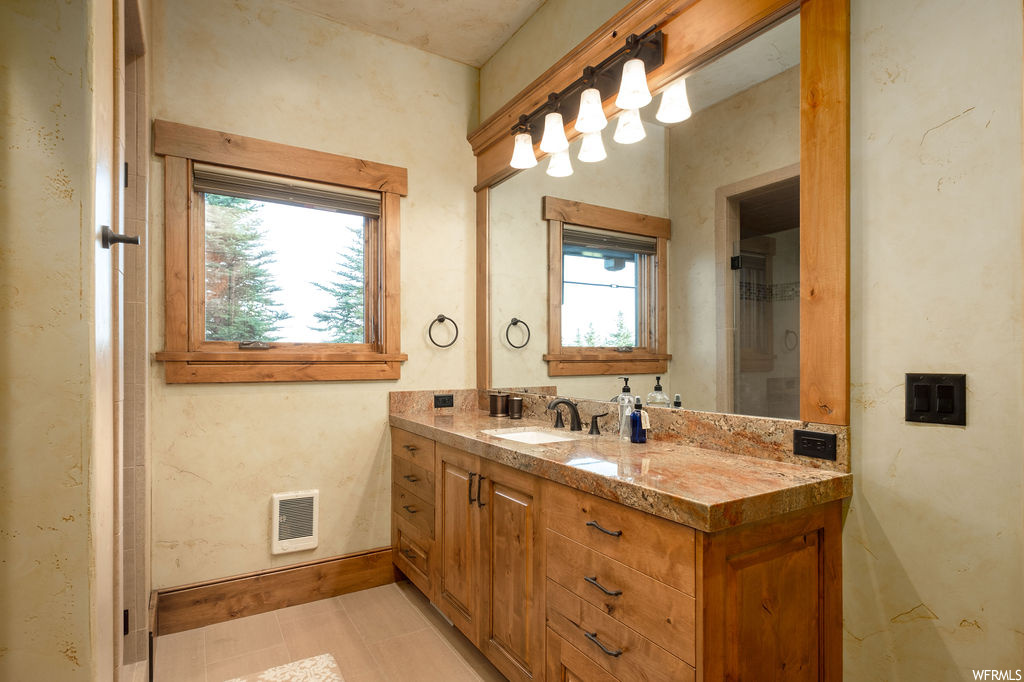 Bathroom with plenty of natural light, mirror, and oversized vanity