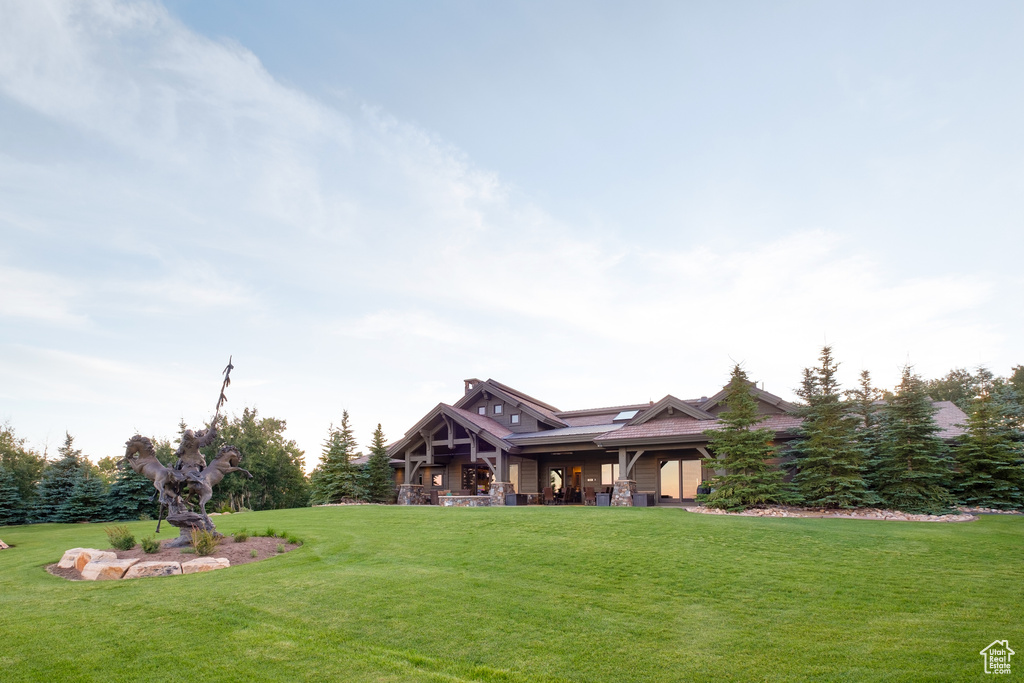 View of front of home featuring covered porch and a front yard