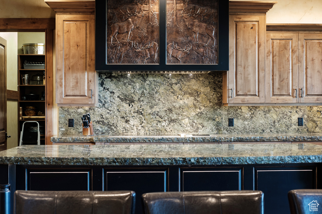 Kitchen with backsplash and dark countertops