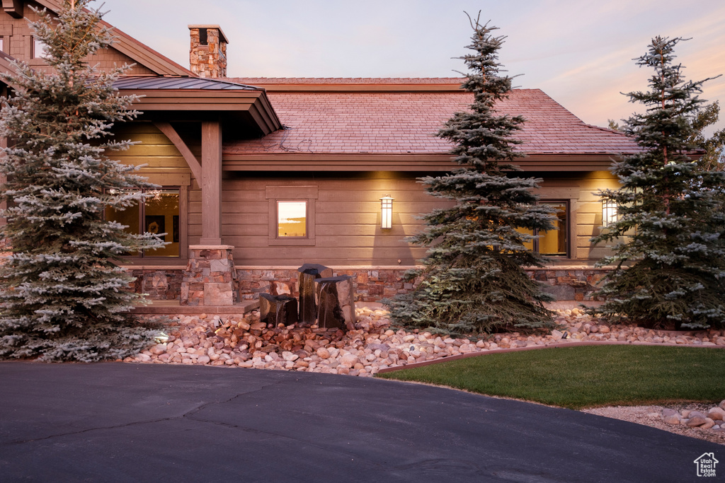 Property exterior at dusk featuring a chimney