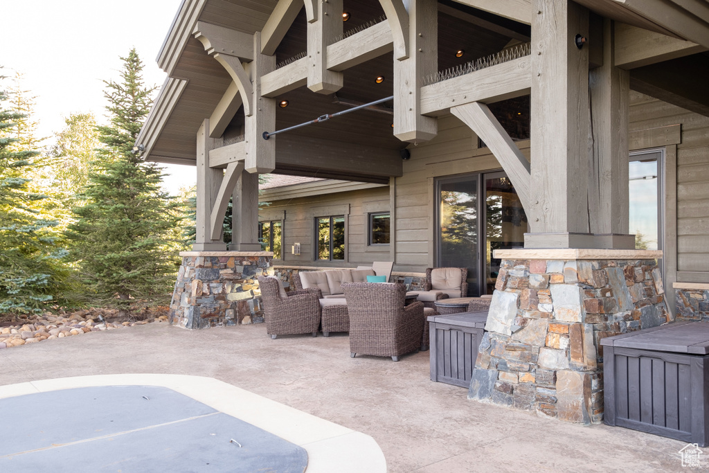 View of patio featuring a balcony and an outdoor hangout area