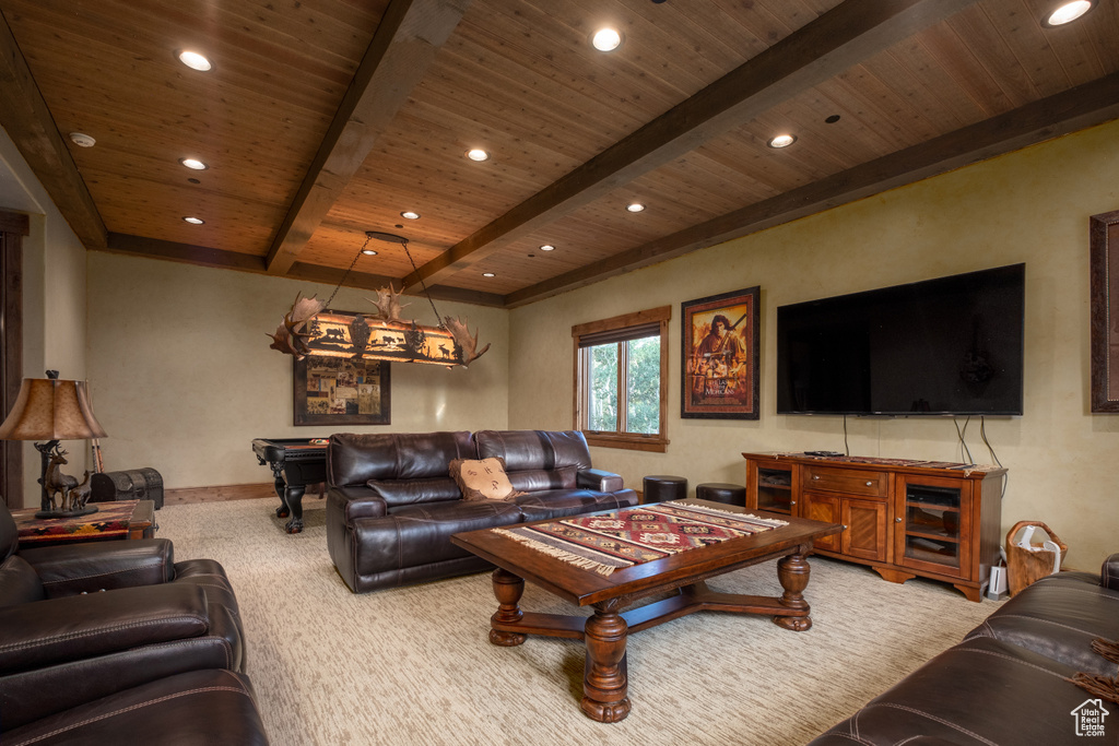 Carpeted living area with baseboards, recessed lighting, beamed ceiling, and wood ceiling
