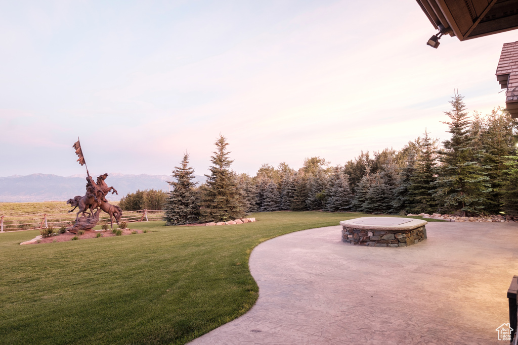 View of community featuring a lawn, a patio, and a mountain view
