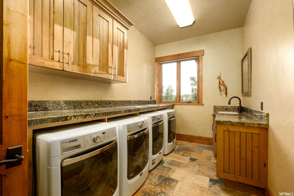 Clothes washing area with tile flooring, natural light, and independent washer and dryer