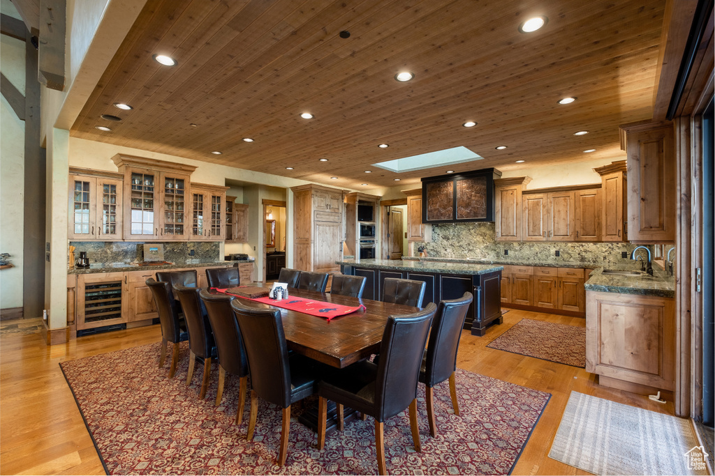 Dining space with recessed lighting, wine cooler, and wooden ceiling