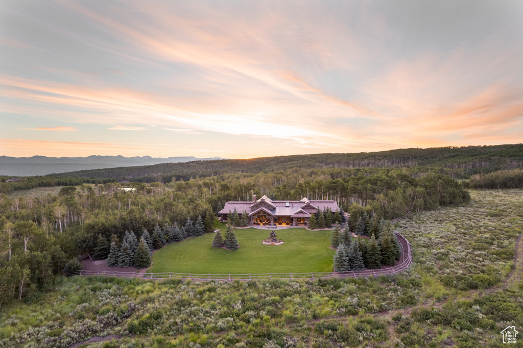 Birds eye view of property with a wooded view