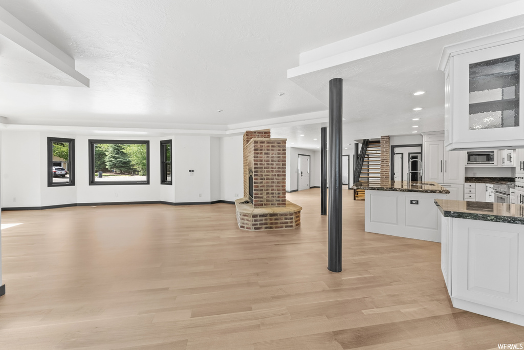 Living room featuring hardwood floors and a healthy amount of sunlight