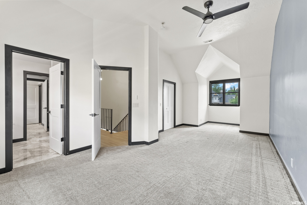 Bonus room with vaulted ceiling and carpet