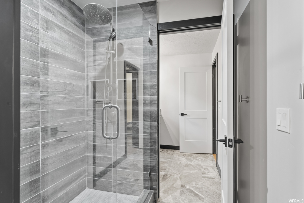 Bathroom with tile floors and shower booth