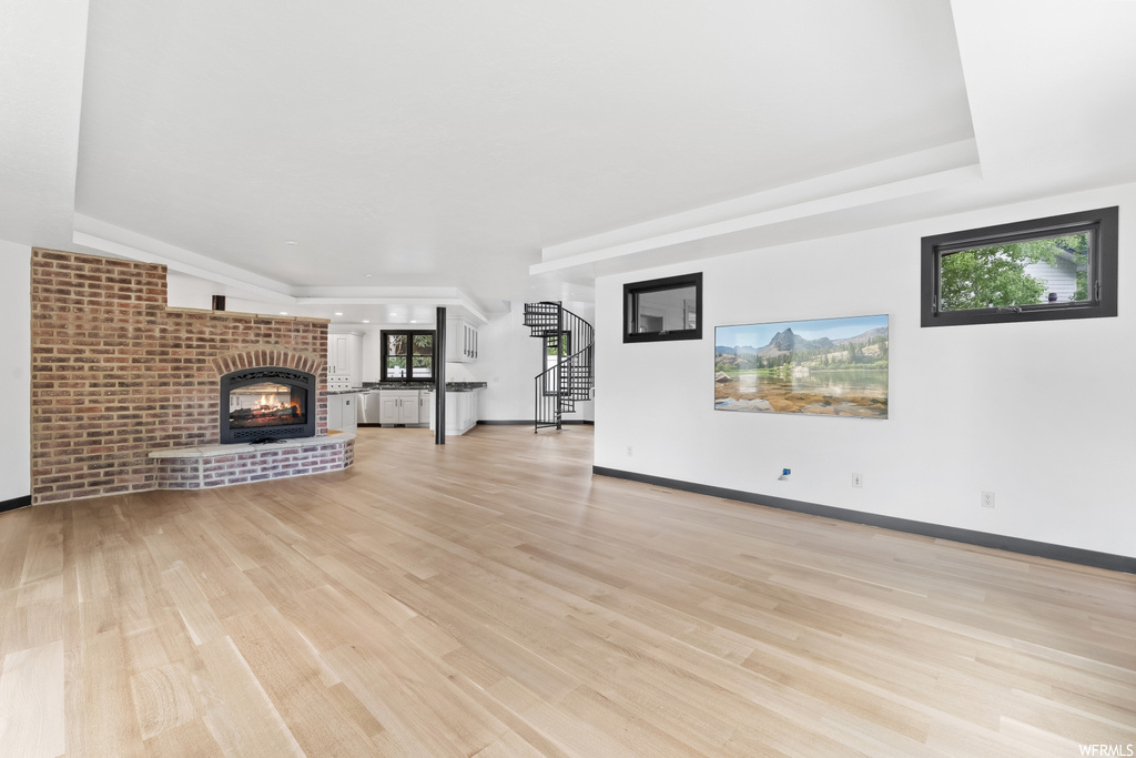 Living room featuring a brick fireplace and hardwood flooring