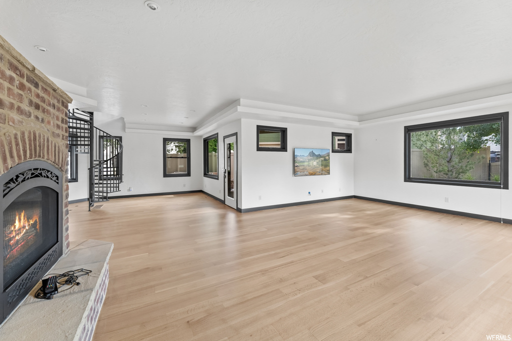 Living room featuring a brick fireplace and natural light