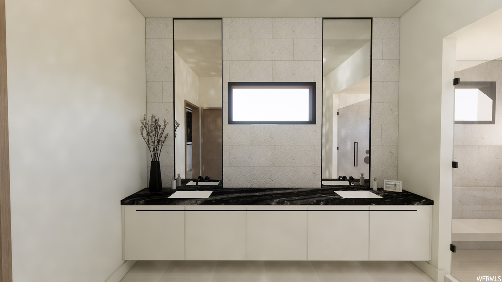 Bathroom with natural light, mirror, and double vanity