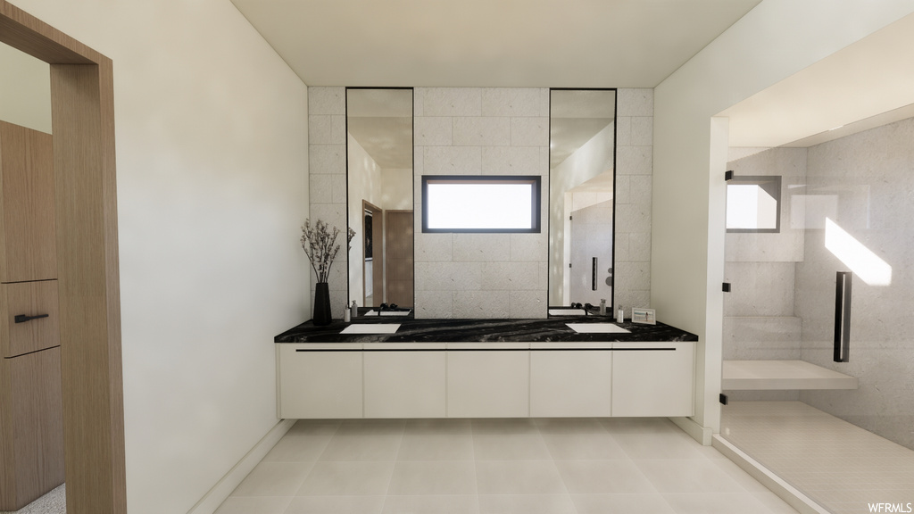 Bathroom with tile flooring, mirror, and dual bowl vanity