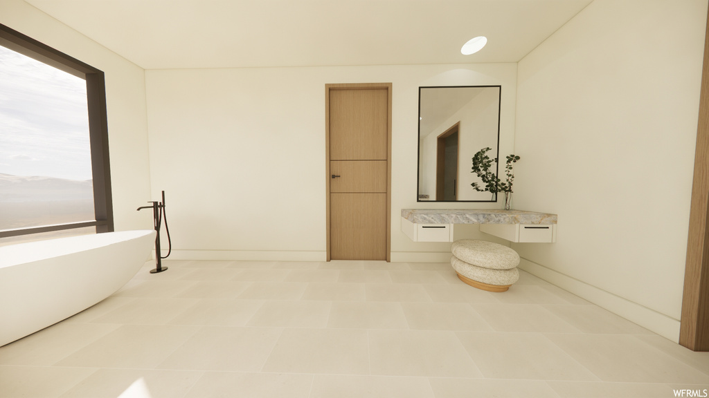 Bathroom with tile floors, mirror, and a tub