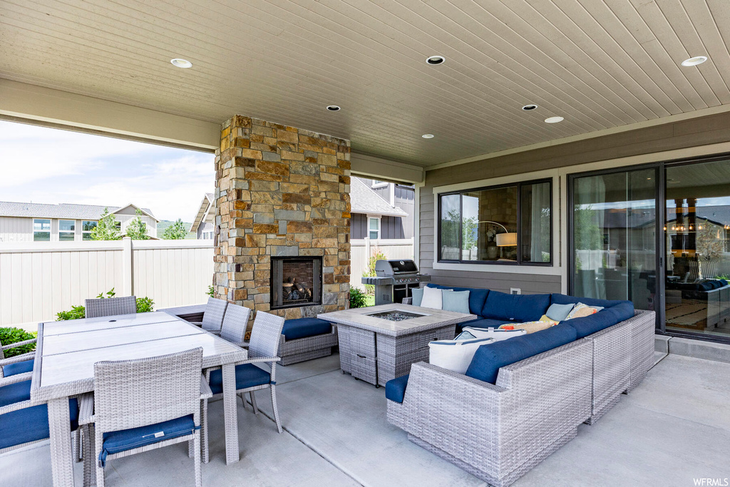 View of patio / terrace featuring an outdoor living space with a fireplace