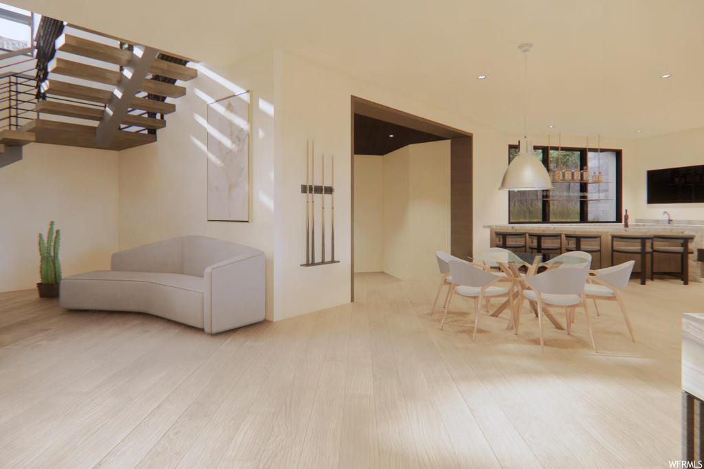 Living room featuring light hardwood / wood-style flooring and a healthy amount of sunlight