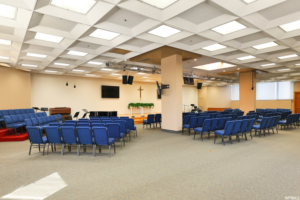 Interior space with carpet and coffered ceiling