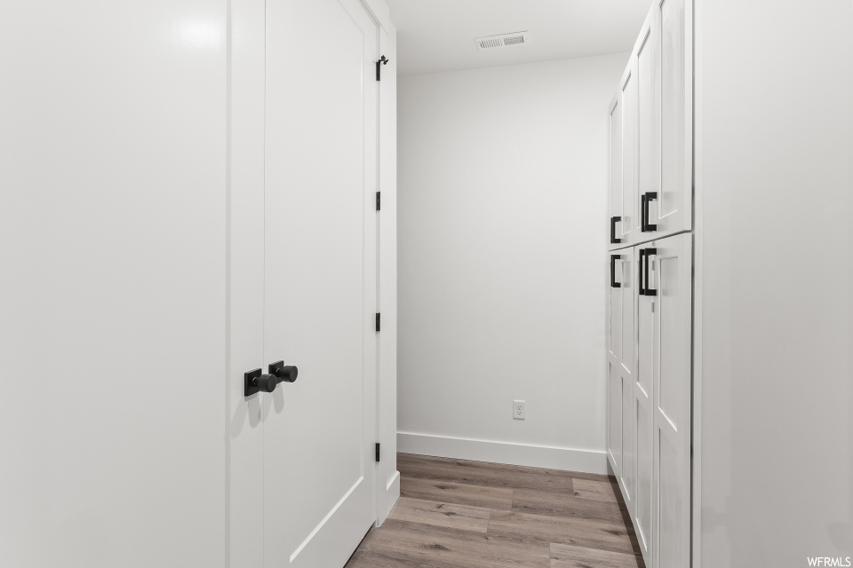 Corridor featuring hardwood floors