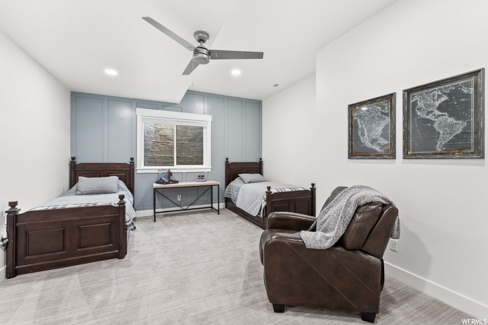 Bedroom with carpet, a ceiling fan, and natural light