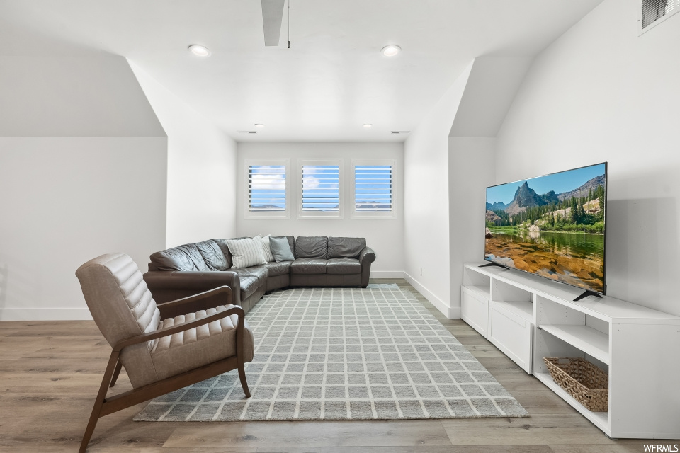 Hardwood floored living room featuring TV
