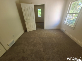 Carpeted spare room with a healthy amount of sunlight