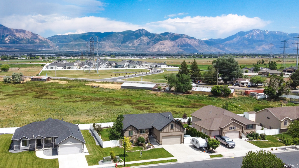 Property view of mountains with a lawn