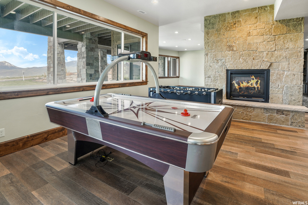 Game room featuring a fireplace and hardwood flooring