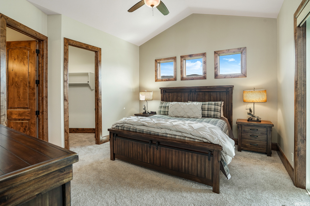 Bedroom featuring vaulted ceiling, carpet, and a ceiling fan