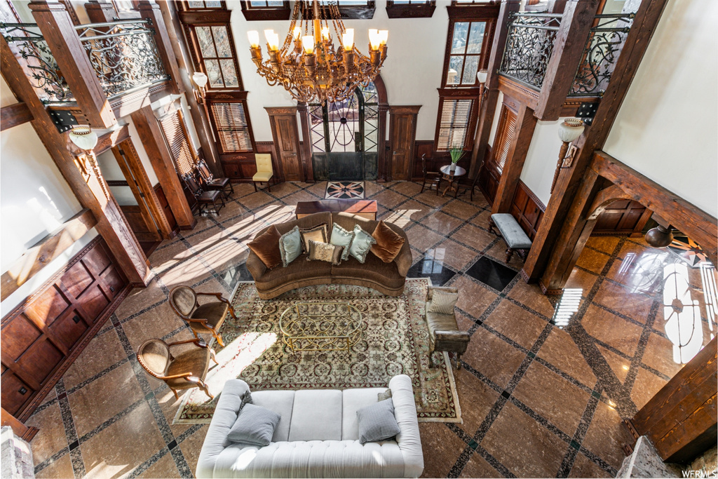 Interior space featuring a notable chandelier and a towering ceiling