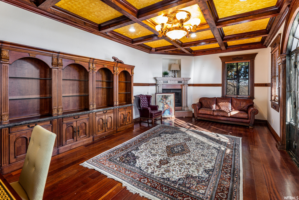 Office space with a notable chandelier, coffered ceiling, beam ceiling, and dark hardwood / wood-style floors