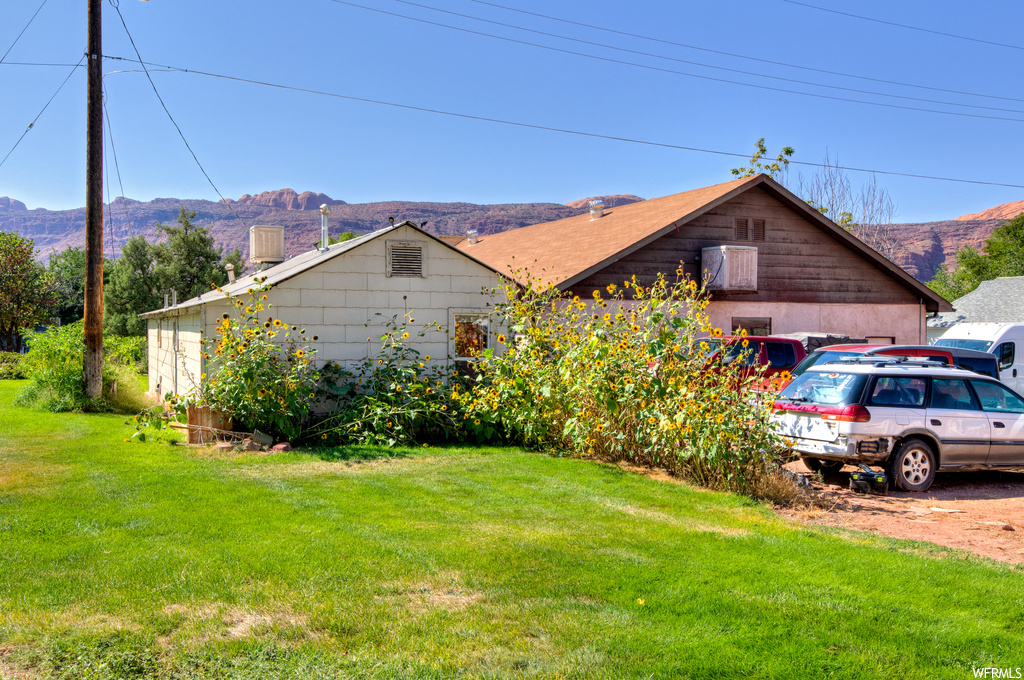 View of side of home with a mountain view