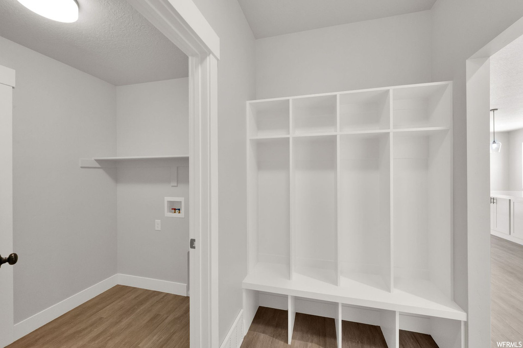 Mudroom with hardwood flooring
