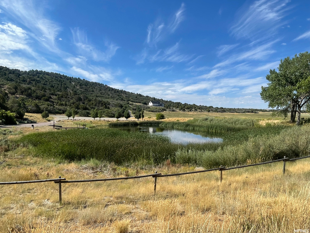 Property view of mountains with a water view