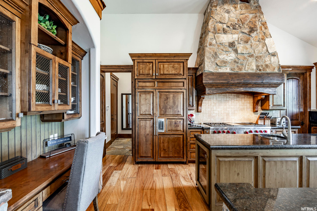 Kitchen with gas cooktop, dark countertops, and light hardwood flooring
