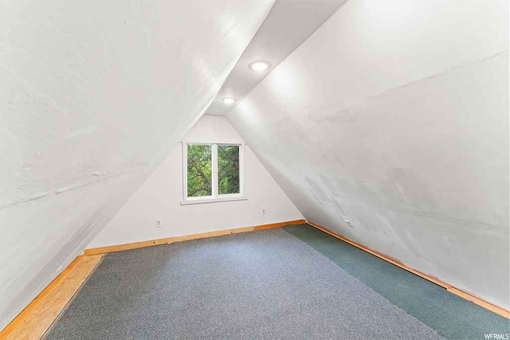 Additional living space with vaulted ceiling and natural light