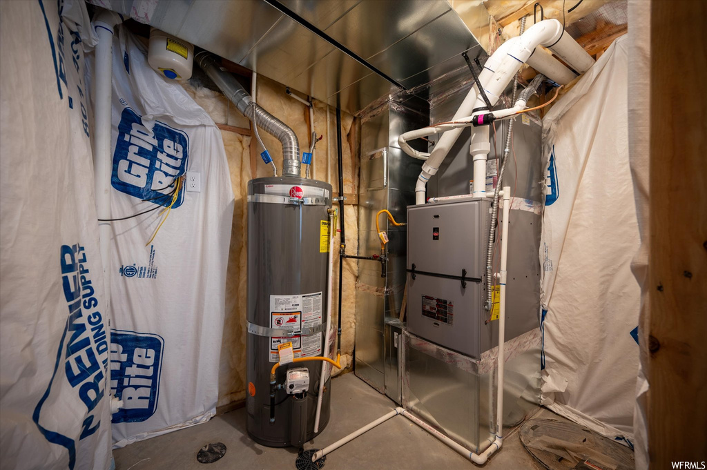 Utility room featuring secured water heater