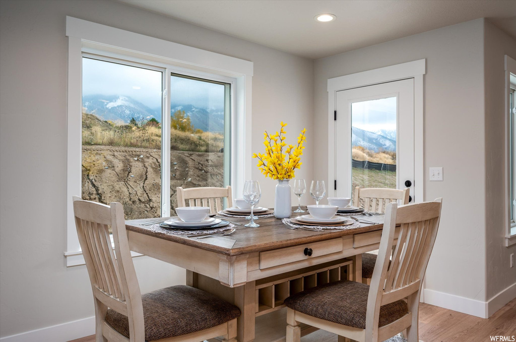 Dining area featuring plenty of natural light, light hardwood / wood-style flooring, and a mountain view