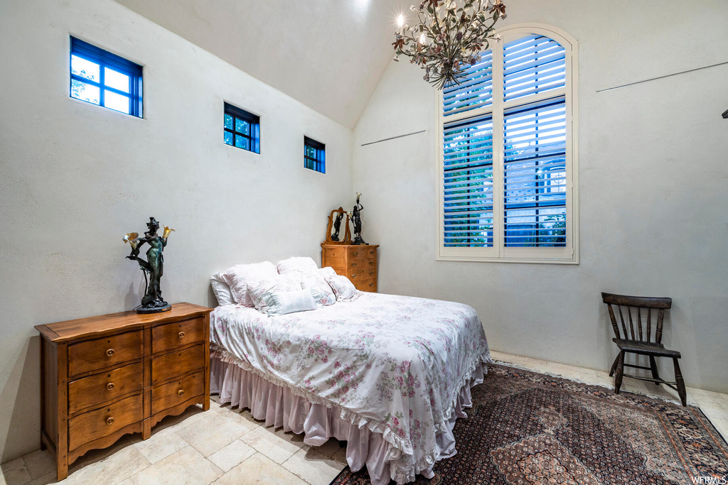 Bedroom featuring tile flooring and multiple windows